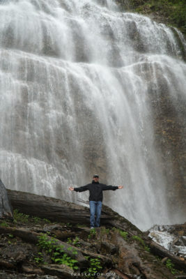 Rob posing under the base of the falls at bridal veil, british columbia.