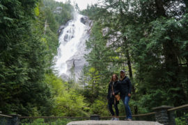 Alicja and her friend posing in front of Shannon Falls on a stone platform made in this area.