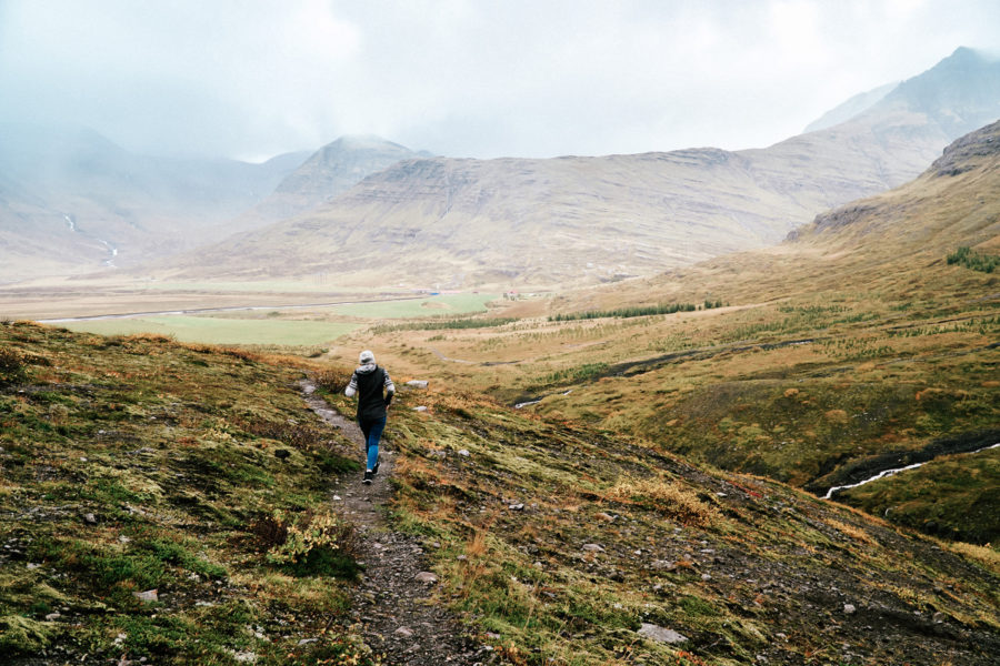 Walking down a small path in the East Fjords Iceland - Kraska Fox